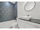 Modern bathroom with a contemporary vanity, large mirror, and a tub with eye-catching geometric tile surround at 34 Candler Ne Rd, Atlanta, GA 30317