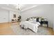 Bright primary bedroom featuring light hardwood floors, modern lighting, and tasteful decor at 34 Candler Ne Rd, Atlanta, GA 30317