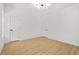 Bright bedroom featuring light hardwood floors and modern lighting at 34 Candler Ne Rd, Atlanta, GA 30317