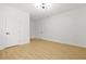 Bright bedroom featuring light hardwood floors and a modern light fixture at 34 Candler Ne Rd, Atlanta, GA 30317