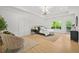 Bright primary bedroom featuring light hardwood floors, modern lighting, and an outdoor view at 34 Candler Ne Rd, Atlanta, GA 30317