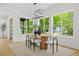 Bright dining room features large windows, contemporary lighting, and wood floors at 34 Candler Ne Rd, Atlanta, GA 30317