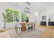 Bright dining room featuring a modern light fixture, a wood table with seating for six, and large windows overlooking the yard at 34 Candler Ne Rd, Atlanta, GA 30317