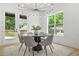 Modern dining room with a unique chandelier and views of the backyard at 34 Candler Ne Rd, Atlanta, GA 30317