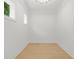 This is an empty room with light-colored walls and wood-look floors and two windows at 34 Candler Ne Rd, Atlanta, GA 30317