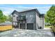 Modern home with gray siding, a balcony, and a two-car garage, nestled among green trees at 34 Candler Ne Rd, Atlanta, GA 30317