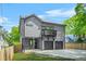 Two-story home featuring gray siding, black trim, two-car garage, and second story balcony at 34 Candler Ne Rd, Atlanta, GA 30317