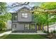Modern two-story home featuring gray siding, black trim, well-manicured lawn and landscaped front yard at 34 Candler Ne Rd, Atlanta, GA 30317