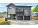 New construction gray home featuring a balcony, a two-car garage, and an inviting front porch at 34 Candler Ne Rd, Atlanta, GA 30317