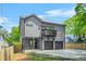 New construction gray home featuring a balcony, a two-car garage, and an inviting front porch at 34 Candler Ne Rd, Atlanta, GA 30317