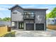 New construction gray home featuring a balcony, a two-car garage, and an inviting front porch at 34 Candler Ne Rd, Atlanta, GA 30317