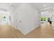 Bright hallway featuring light hardwood floors and white walls with views to the outside at 34 Candler Ne Rd, Atlanta, GA 30317