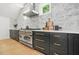 The gourmet kitchen has stainless steel appliances, custom cabinets, and a marble backsplash at 34 Candler Ne Rd, Atlanta, GA 30317