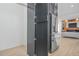 View of the sleek, stainless steel refrigerator in the open kitchen and living space at 34 Candler Ne Rd, Atlanta, GA 30317
