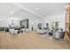 Open-concept living room and kitchen with hardwood floors, modern decor, and bright natural light at 34 Candler Ne Rd, Atlanta, GA 30317