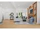 Open-concept living room with hardwood floors, modern decor, and an accent wall at 34 Candler Ne Rd, Atlanta, GA 30317