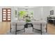 Bright living room with hardwood floors, white walls, modern furniture, and large windows showcasing the outdoors at 34 Candler Ne Rd, Atlanta, GA 30317