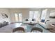 Bright living room with stylish sofas, modern decor, and plenty of natural light at 408 Chaleur Way, Locust Grove, GA 30248