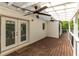 Covered back porch with ceiling fans and a wood deck, creating a perfect outdoor living space for relaxing and entertaining at 1334 Milton Se Pl, Atlanta, GA 30316