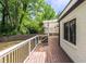 Wooden deck featuring white and black railings with a white pergola and a well-manicured lawn at 1334 Milton Se Pl, Atlanta, GA 30316