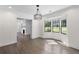 Charming dining area with bay window, modern chandelier, and wood floors at 1334 Milton Se Pl, Atlanta, GA 30316