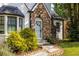 Close-up of the home's stone accent, white door with sidelights, and bay window, creating a warm and inviting entrance at 1334 Milton Se Pl, Atlanta, GA 30316