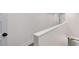 Bright white hallway with hardwood floors, wainscoting, and a white painted wooden handrail and banister at 1334 Milton Se Pl, Atlanta, GA 30316