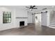 Bright living room with wood floors, a painted brick fireplace, and sliding barn doors creating an open layout at 1334 Milton Se Pl, Atlanta, GA 30316
