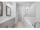 Modern bathroom with double vanity, wood-framed mirrors, and a glass-enclosed shower and tub combo at 3167 Moor View Rd # 35, Duluth, GA 30096
