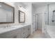 Modern bathroom with double vanity, wood-framed mirrors, and a glass-enclosed shower and tub combo at 3167 Moor View Rd # 35, Duluth, GA 30096