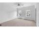 Bright bedroom features carpeted floors, white walls, and two windows for natural light at 3167 Moor View Rd # 35, Duluth, GA 30096
