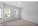 Bright bedroom with carpeted floors and windows showcasing the outside neighborhood at 3167 Moor View Rd # 35, Duluth, GA 30096