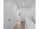 Bright hallway with white walls, wood floors and natural light leading to the bedrooms at 3167 Moor View Rd # 35, Duluth, GA 30096