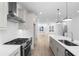 Open-concept kitchen featuring stainless steel appliances and wood floors at 3167 Moor View Rd # 35, Duluth, GA 30096