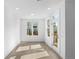 Bright room with hardwood floors, white walls, windows and a door to outside at 3167 Moor View Rd # 35, Duluth, GA 30096