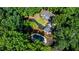 Aerial view of home with a long driveway and a kidney-shaped pool at 5205 Riverview Nw Rd, Atlanta, GA 30327
