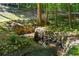 Landscaped backyard with a creek and stone retaining walls at 5205 Riverview Nw Rd, Atlanta, GA 30327