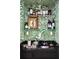 Chic bar area featuring palm wallpaper, mirrored shelves with glassware, a black countertop, and warm lighting, perfect for entertaining at 5205 Riverview Nw Rd, Atlanta, GA 30327