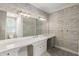 Bright bathroom featuring wood-look accent wall, marble countertop, shower, and mosaic tile flooring at 5205 Riverview Nw Rd, Atlanta, GA 30327