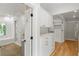 Luxurious walk-in closet and dressing area features a spa-like bathroom and custom built-ins at 5205 Riverview Nw Rd, Atlanta, GA 30327