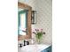 Stylish bathroom features a decorative mirror, patterned wallpaper, and elegant fixtures at 5205 Riverview Nw Rd, Atlanta, GA 30327