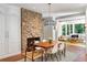 Cozy dining area with brick floors, a fireplace, and a view into a living room at 5205 Riverview Nw Rd, Atlanta, GA 30327