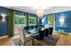 Elegant dining room boasting blue wallpaper, stylish lighting, and seating for ten at 5205 Riverview Nw Rd, Atlanta, GA 30327