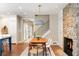 Dining area with brick floors and an adjacent stone fireplace near the kitchen at 5205 Riverview Nw Rd, Atlanta, GA 30327