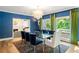 Stylish dining room with large windows, decorative chandelier and blue accent wall at 5205 Riverview Nw Rd, Atlanta, GA 30327