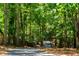 Long driveway through lush trees provides privacy for the home at 5205 Riverview Nw Rd, Atlanta, GA 30327