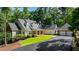 Traditional-style home features a large driveway and an attached garage at 5205 Riverview Nw Rd, Atlanta, GA 30327