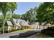 Stunning home showcasing stone and siding exterior, covered front porch, and lush landscaping at 5205 Riverview Nw Rd, Atlanta, GA 30327