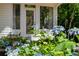 Charming exterior featuring a stone birdbath and flowering hydrangeas near the entrance of this lovely home at 5205 Riverview Nw Rd, Atlanta, GA 30327