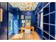 Stylish blue home office with custom shelving, wood desk, and unique ceiling at 5205 Riverview Nw Rd, Atlanta, GA 30327